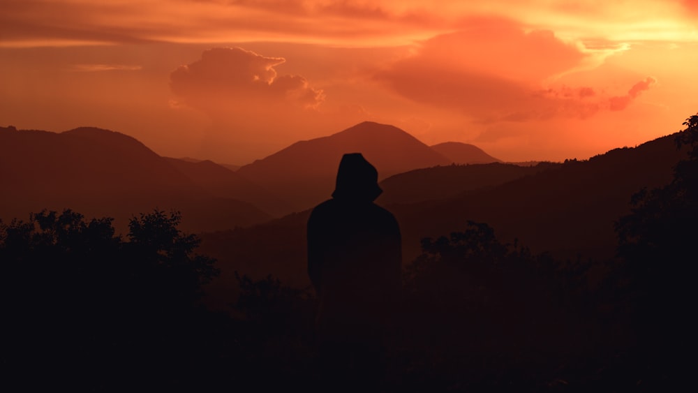 silhouette of person wearing hoodie