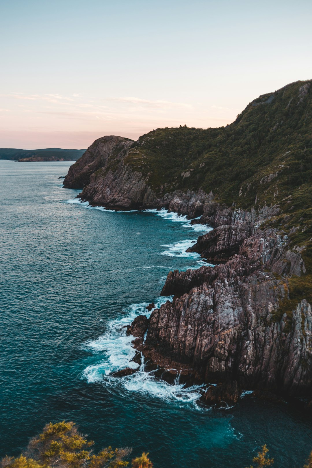 body of water beside mountains