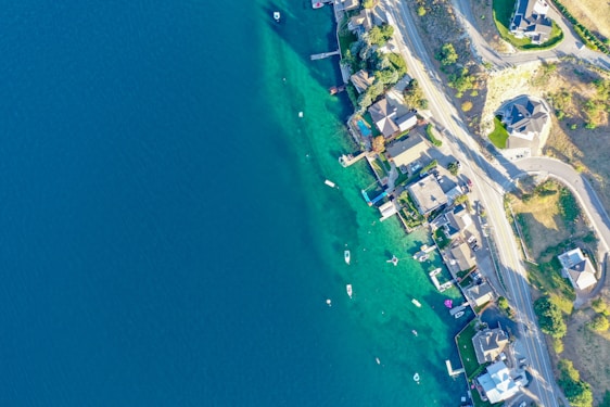 Aerial photograph of a coastal landscape with clear water and boats.