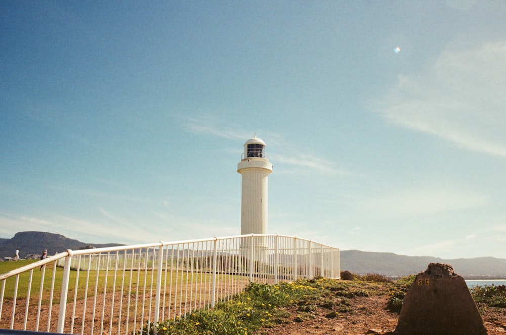 white lighthouse near body of water