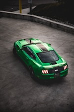 green Ford Mustang on road