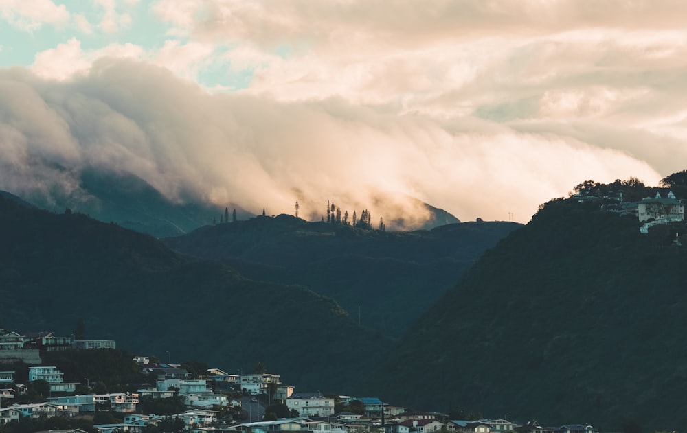 city on the hills under cloudy sky