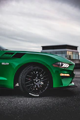a green sports car parked in a parking lot