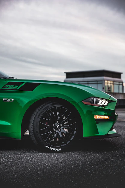 a green sports car parked in a parking lot