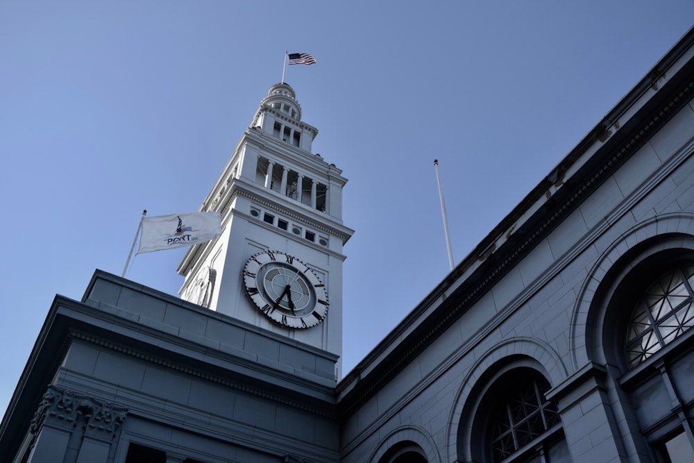 building with clock and flags