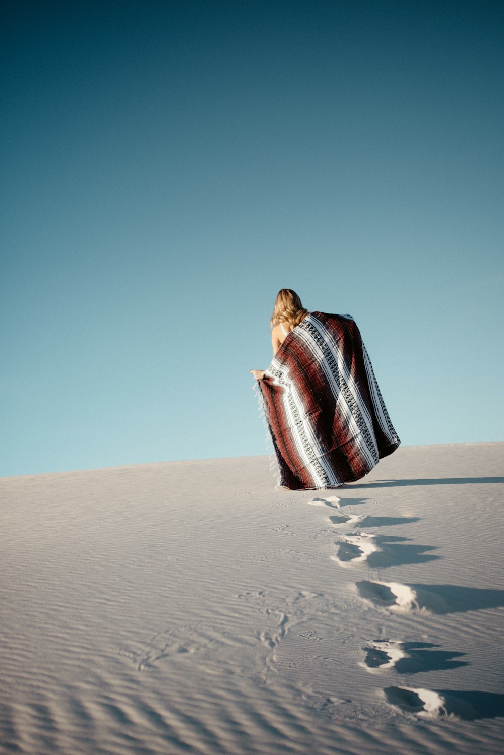 woman walks at the desert with scarf