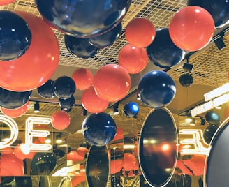 A vibrant party venue decorated with colorful balloons and lights.
