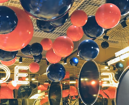 Corporate event space decorated with sleek, modern balloon installations.