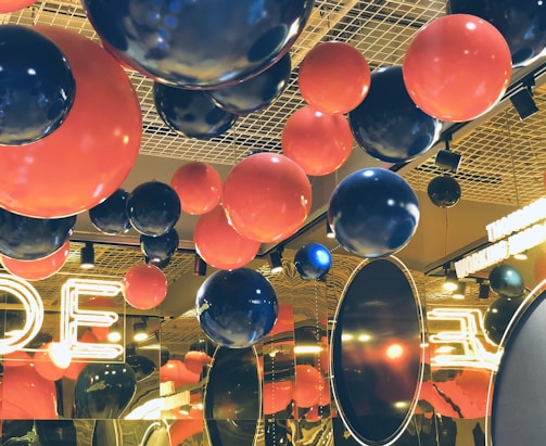 A vibrant party venue decorated with colorful balloons and lights.