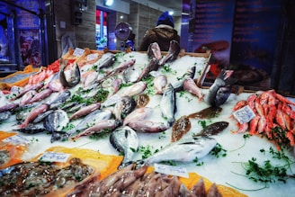 A vibrant display of fresh fish on ice at a market stall.