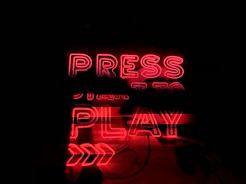 A vibrant neon-themed streaming service category with play buttons and digital waves.