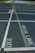 View of a running track with multiple lanes, white lane dividers, and a conspicuously marked break line. The number 100 is clearly visible along with a directional arrow pointing forward. A section of the track is highlighted in blue with large white lettering in the distance.