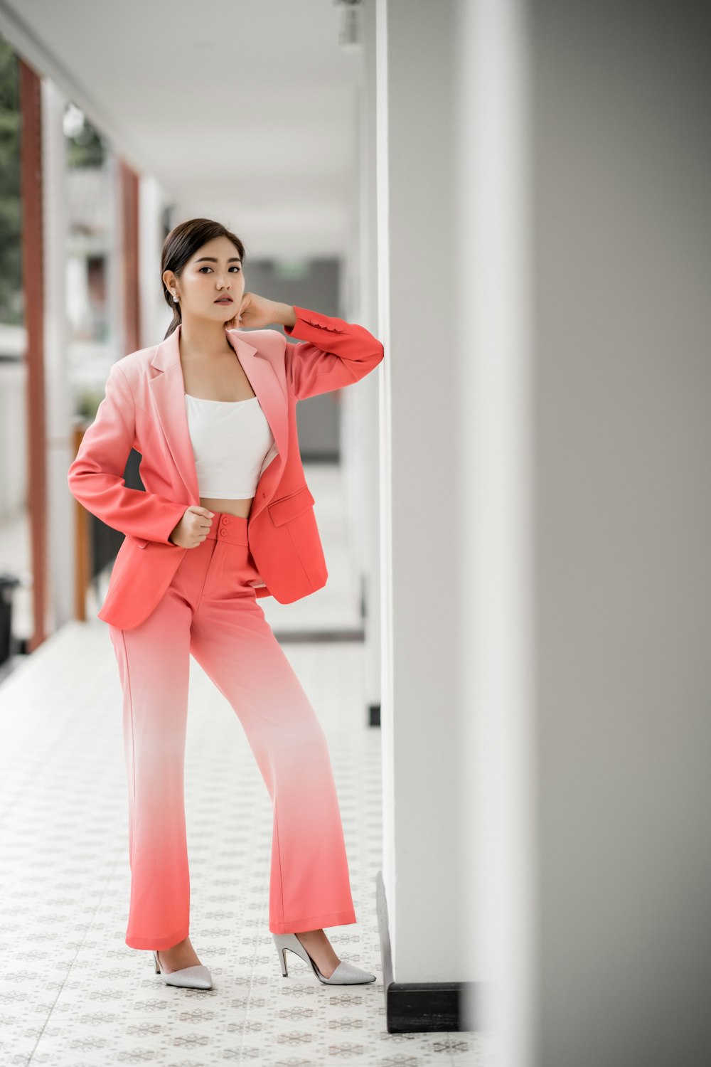 woman in white top and red 2-piece suit