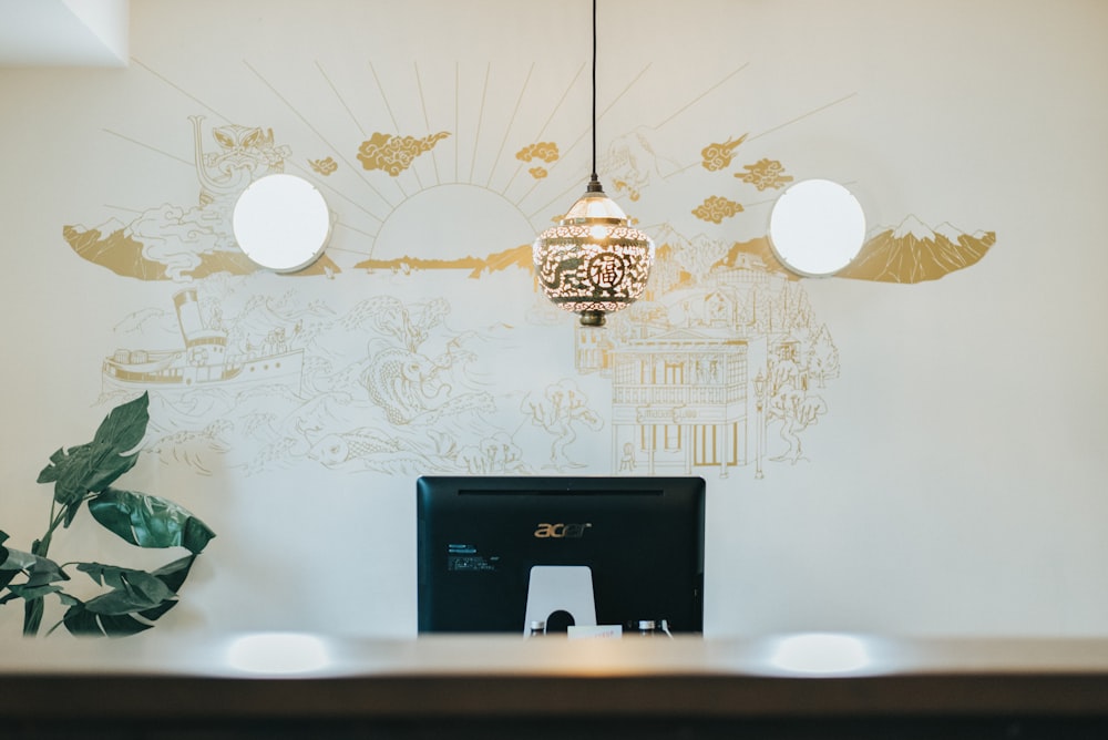 black and gray pendant lamp near white wall