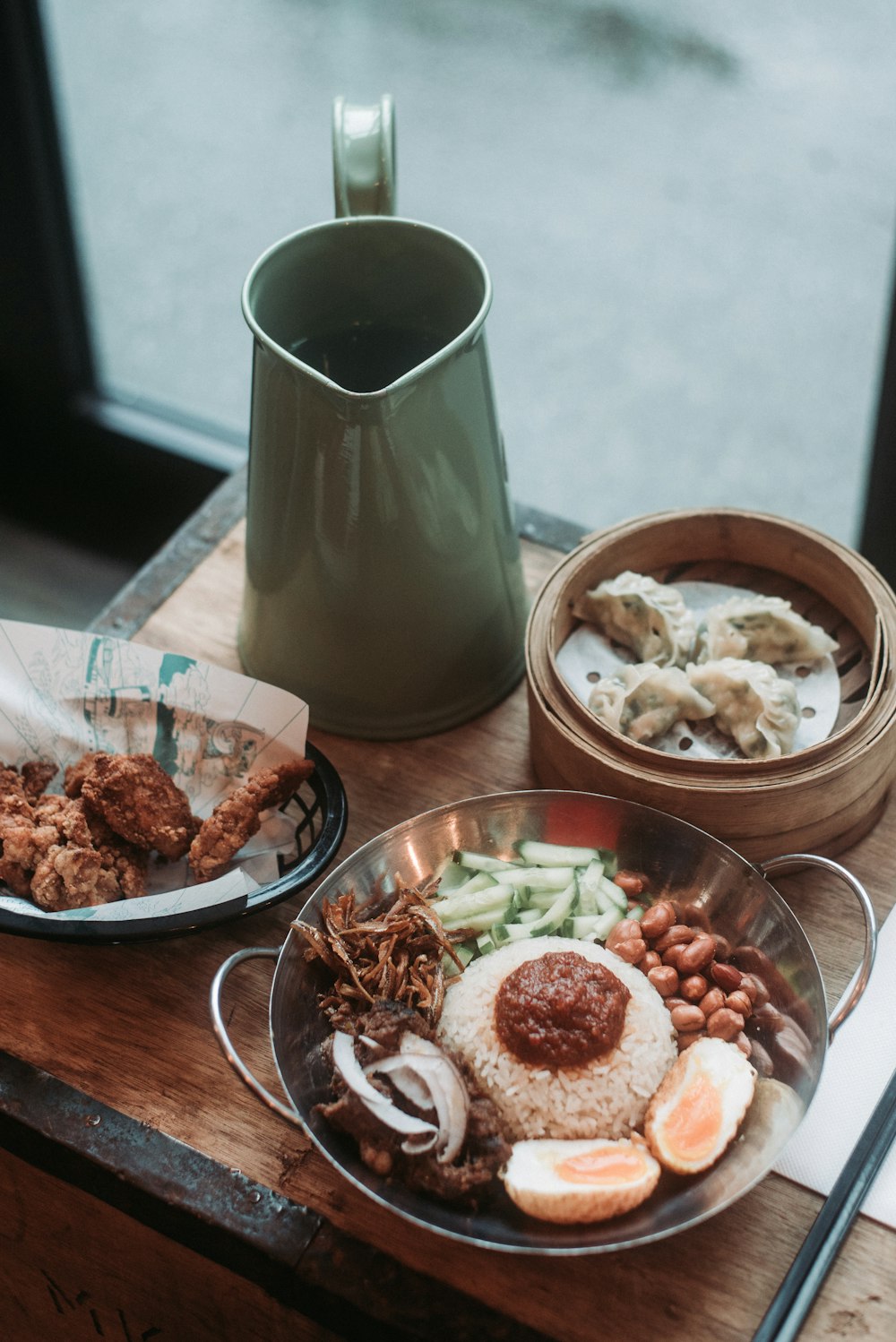 selective focus photography of three bowls of food beside pitcher