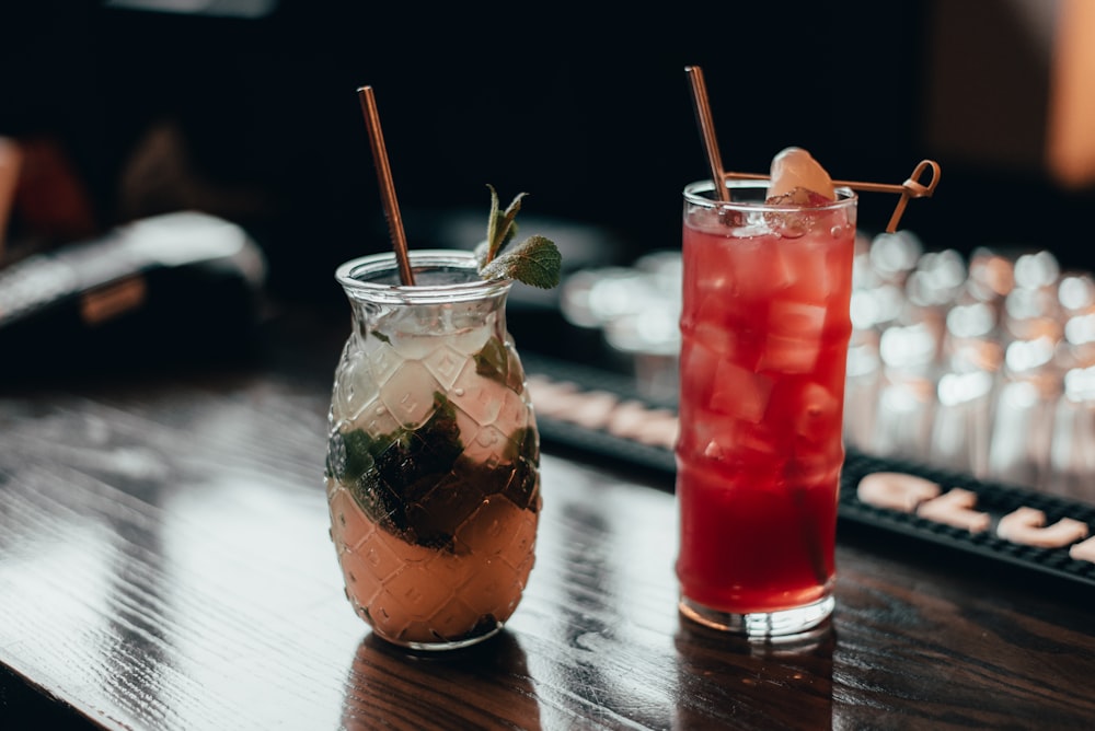 selective focus photography of two drinks on black wooden table