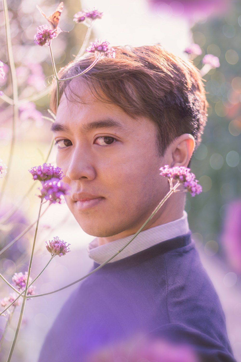 man near purple flowers