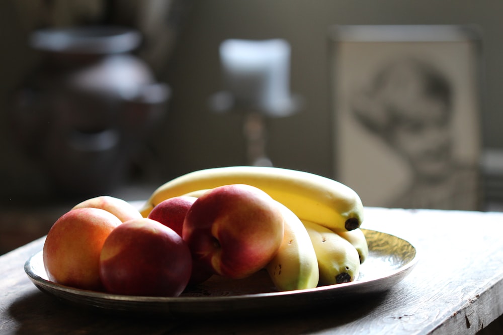 selective focus photography of fruits on plate on brown wooden table