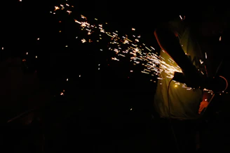 Close-up of a cordless drill in action with sparks flying