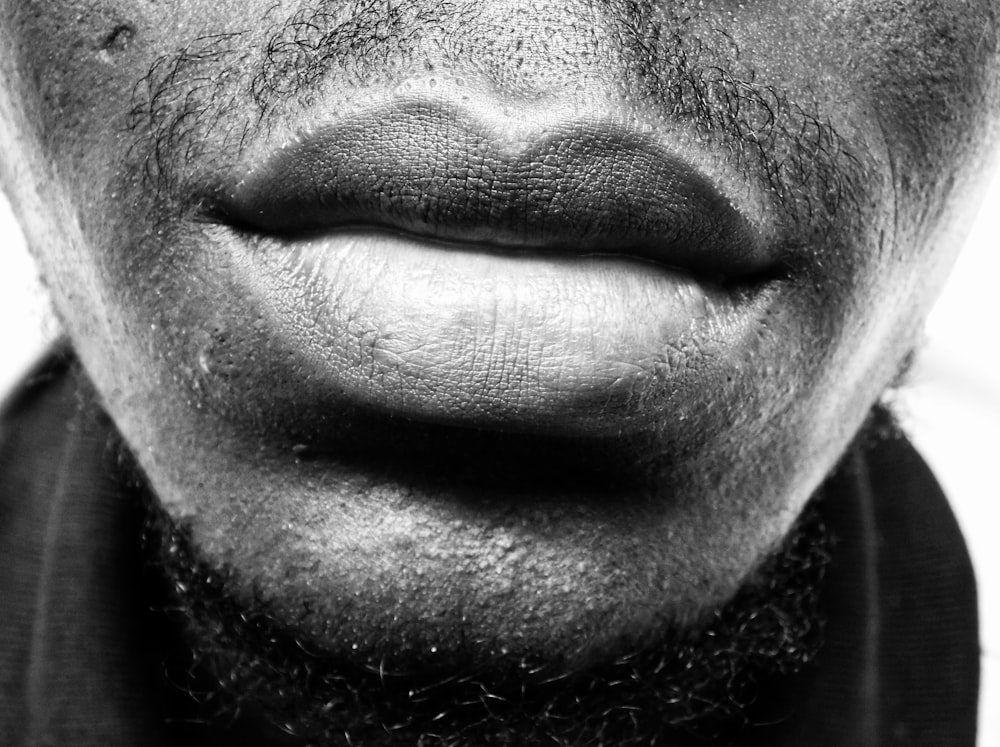 grayscale photo of man's lips and beard