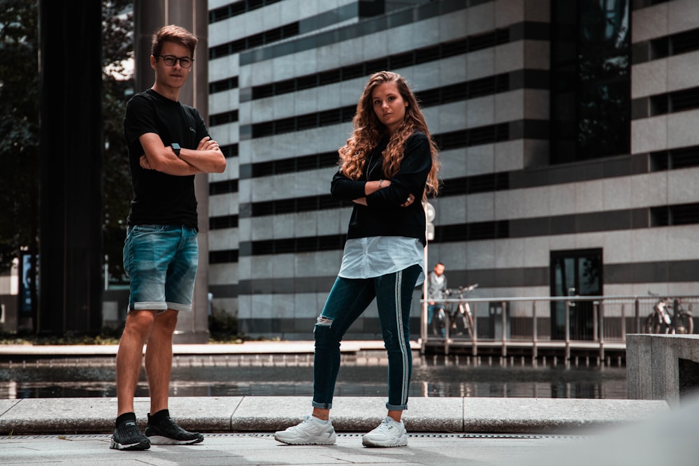 man and woman standing near building
