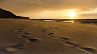 A romantic sunset over a tranquil beach.