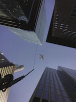 Aerial view of Miami’s skyline with a private jet cruising smoothly overhead.