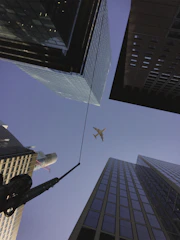 A sleek airplane flying over Chicago’s skyline with Lake Michigan in the background.