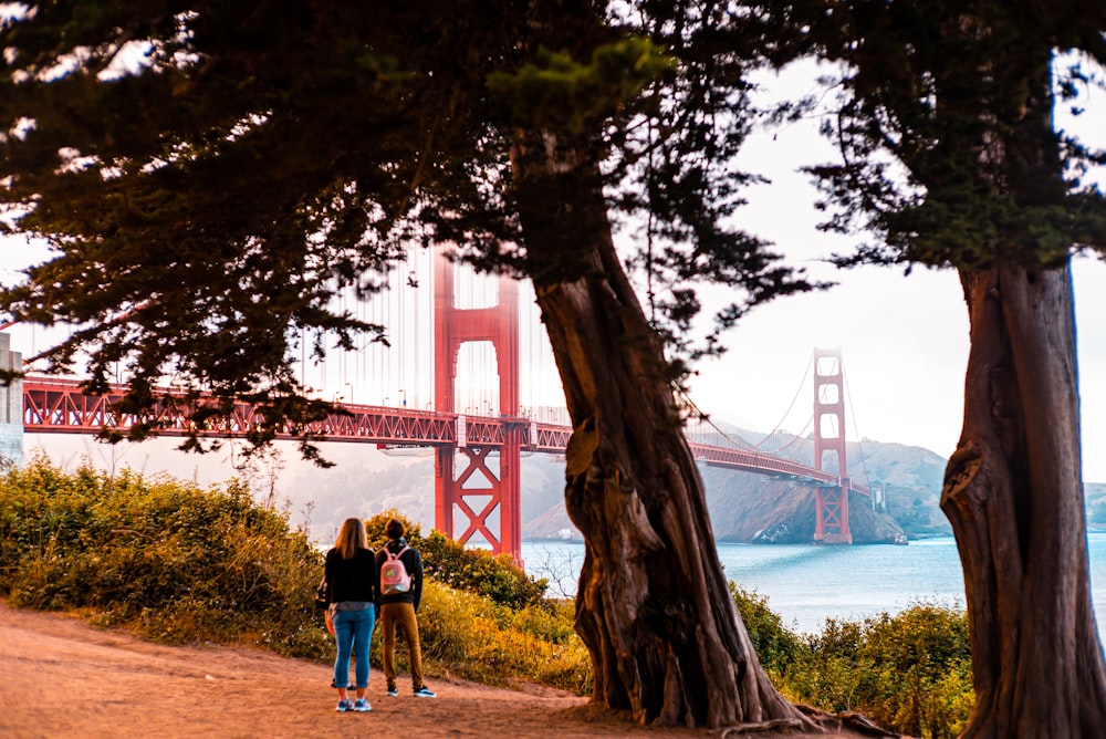 two women standing near Golden Gate Bridge
