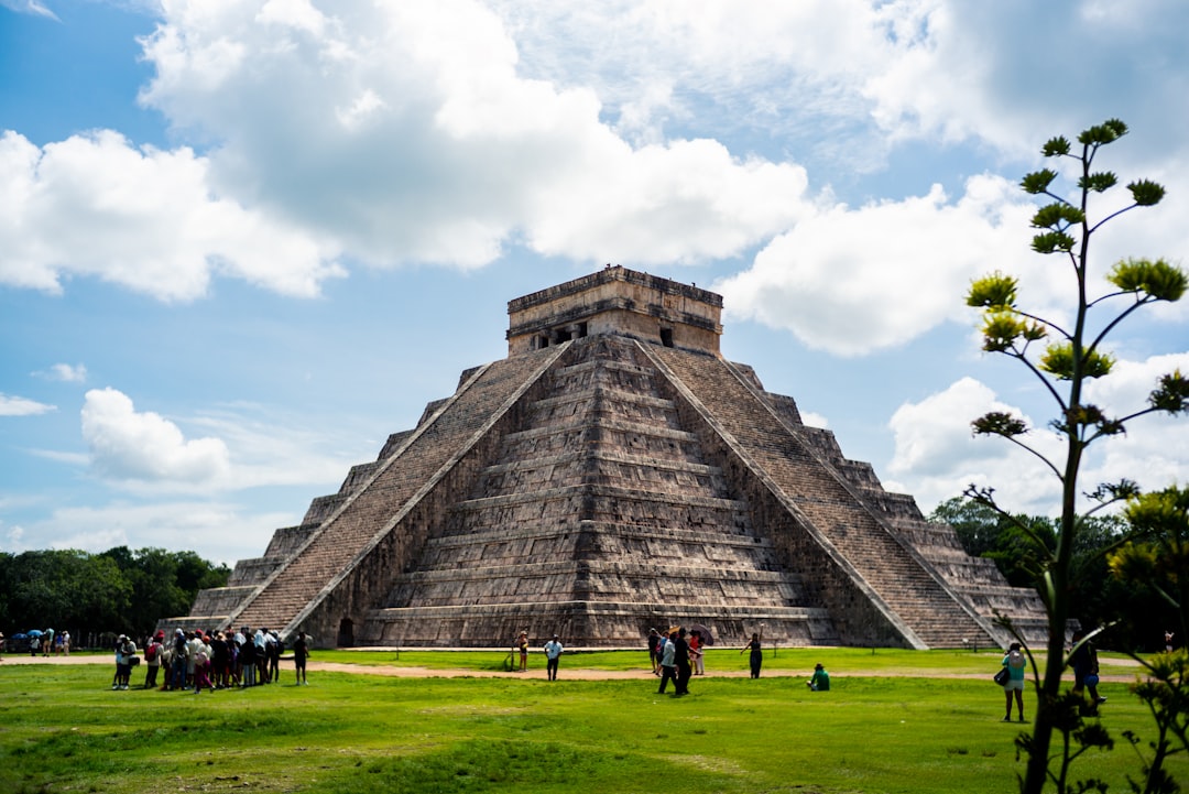 people in Chichen Itza under blue and white skies during daytime
