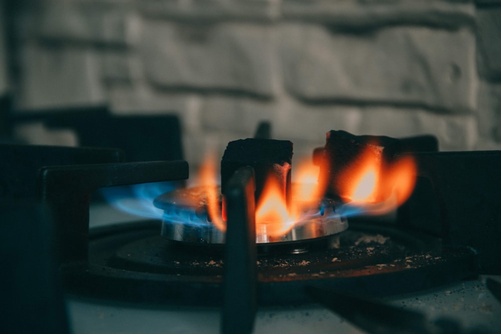 selective focus photography of stove with fire