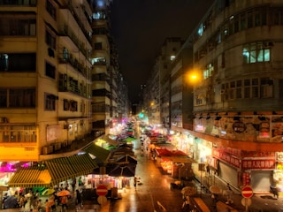A vibrant street scene in Geylang Serai with colorful market stalls and smiling locals.