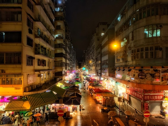 A vibrant street scene in Geylang Serai with colorful market stalls and smiling locals.