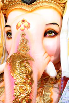 Hands gently painting delicate details on a Ganpati idol, highlighting traditional Indian craftsmanship.