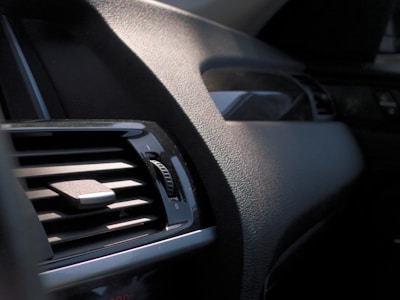 Close-up of a car dashboard showing a cold air vent with frost.