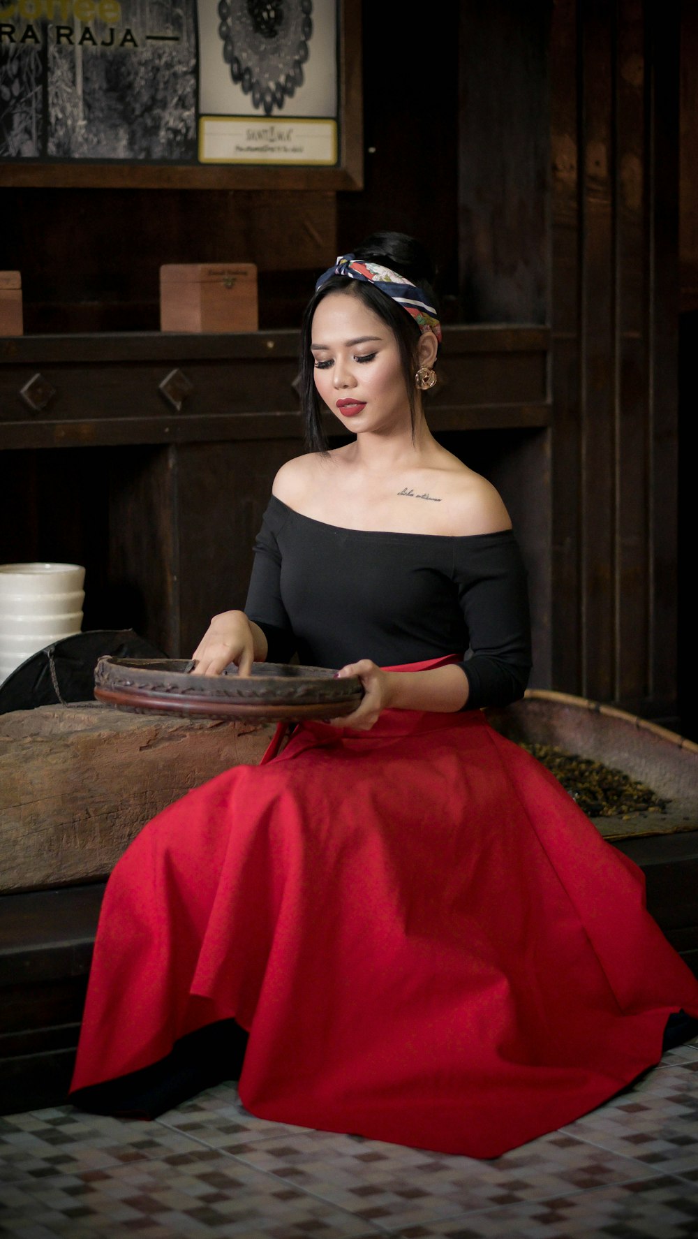 woman holding basket sitting on wood