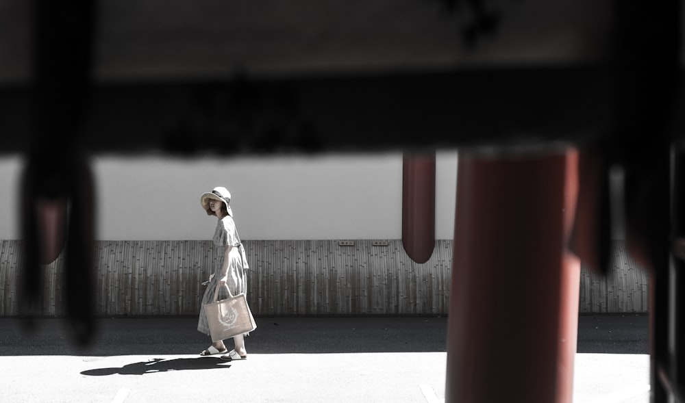 woman wearing white dress walking on pathway