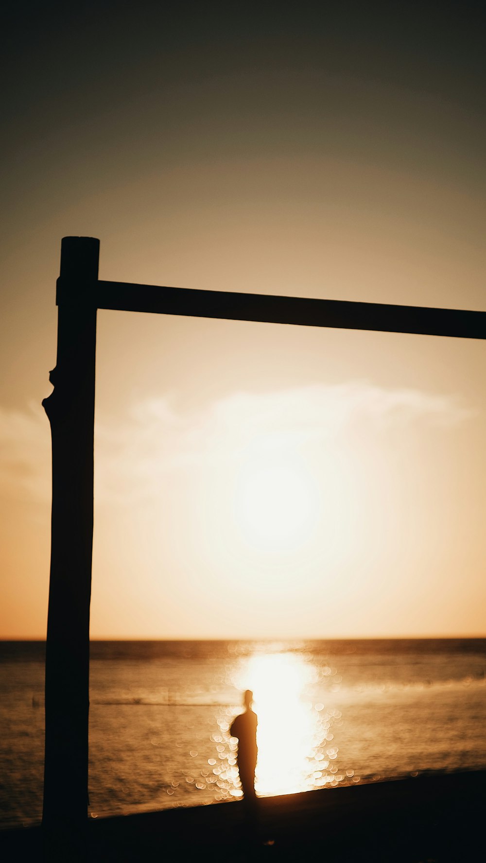 a person standing on a beach next to the ocean