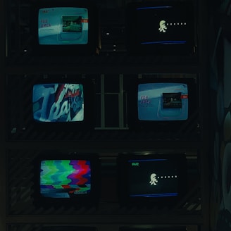 a bunch of tvs that are sitting on a shelf