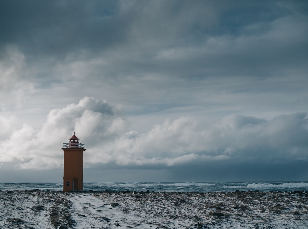 brown concrete lighthouse under cloudy sky during daytime