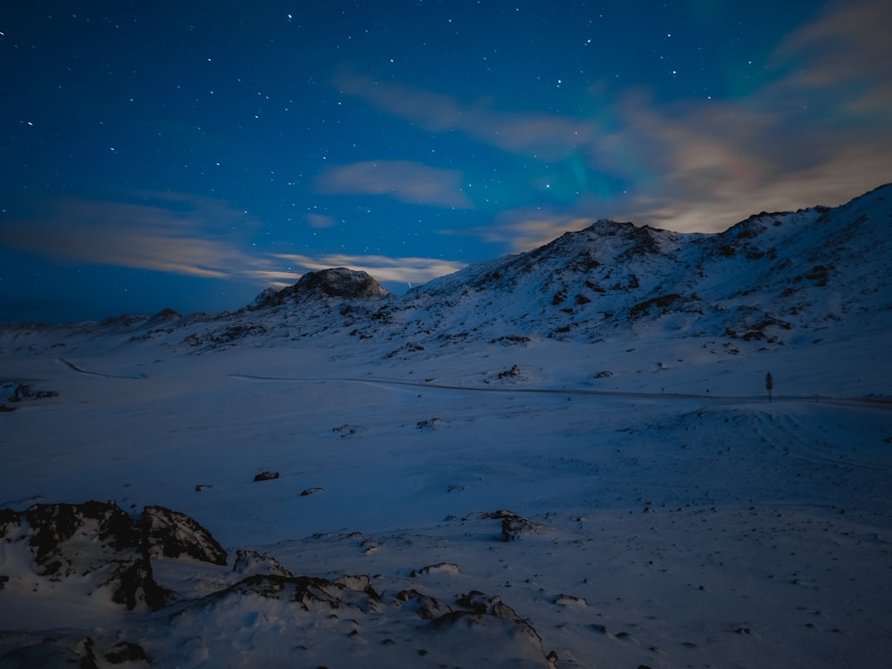 field and mountain covered with snow