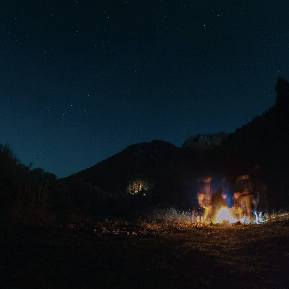 people gathering on bonfire