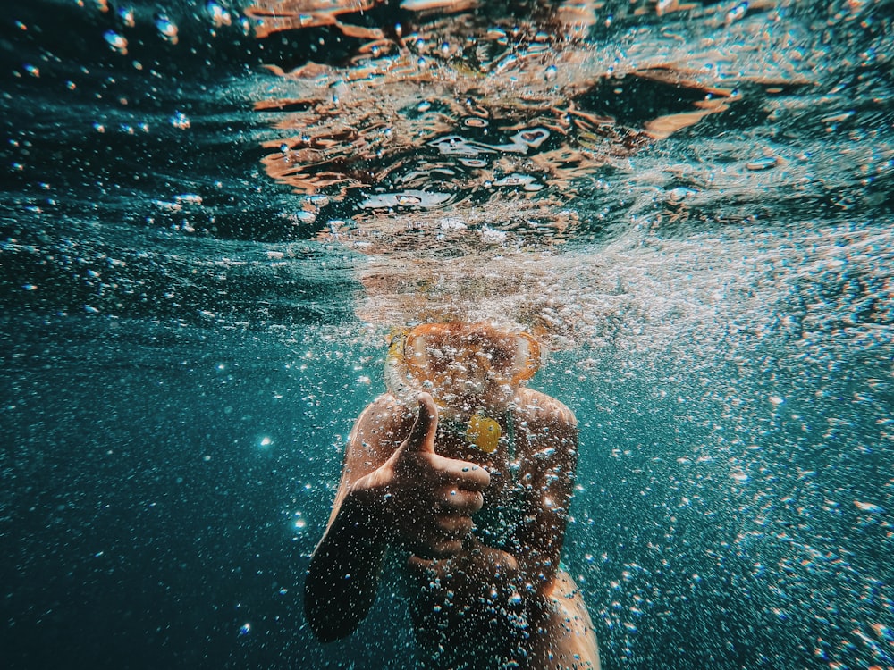 boy wearing goggles underwater