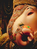 Close-up of a beautifully detailed handcrafted Ganesha idol with vibrant colors.