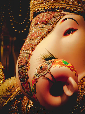 Close-up of a beautifully detailed handcrafted Ganesha idol with vibrant colors.