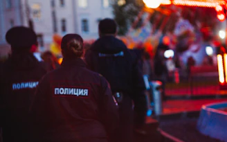 Uniformed security personnel conducting a thorough patrol at night.