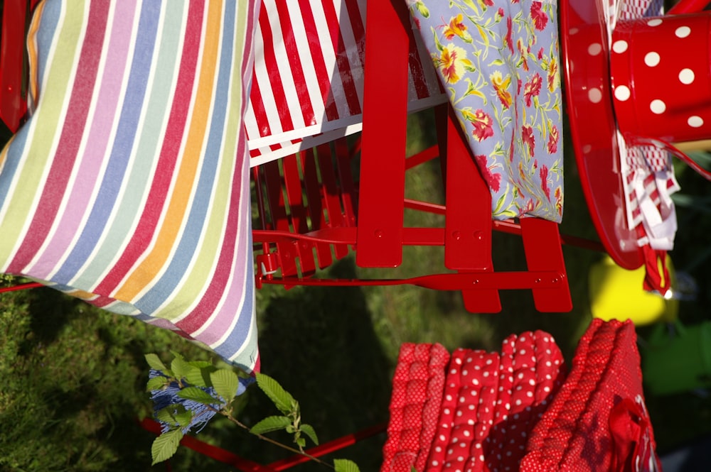 a red chair with a striped pillow on it