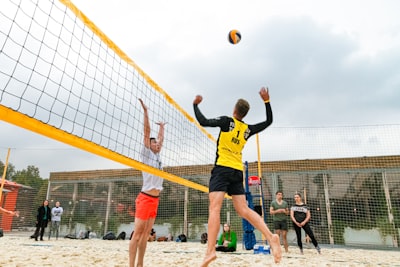 man wearing yellow and black long-sleeved shirt playing volleyball volleyball zoom background