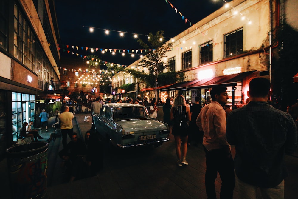 people near car during nighttime