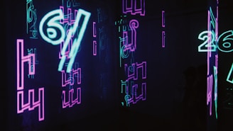 neon signs are lit up in a dark room